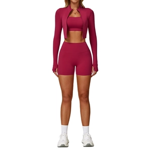 Three-piece magenta yoga set including zip-up jacket, sports bra, and high-waist shorts