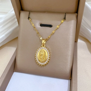 Detailed macro view of the gold Virgin Mary oval pendant necklace with zircon inlay