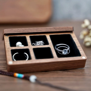 Macro detail of black walnut jewelry box with 5 compartments and soft black velvet lining