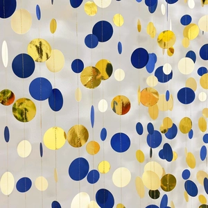 Close-up of blue, beige and gold metallic dot paper garlands hanging for party decoration