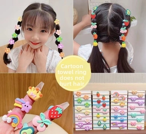 Close-up of elastic cartoon hair ties for girls featuring soft resin charms in candy colors