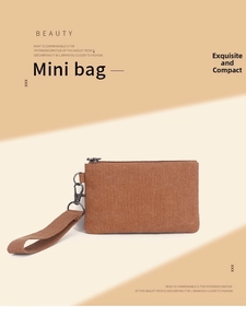 Detail view of vintage red canvas mini coin purse with metal zipper and wrist strap