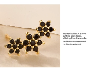 Macro shot of gold plated earrings featuring three connected black cubic zirconia flowers