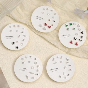 Variety set of minimalist stud earrings including hearts and stars on display cards
