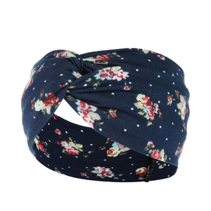 Close-up of dark blue paisley yoga headband with knot detail and floral prints