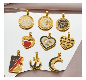 Macro shot of gold-plated tree of life pendants with colorful enamel and zircon inlays