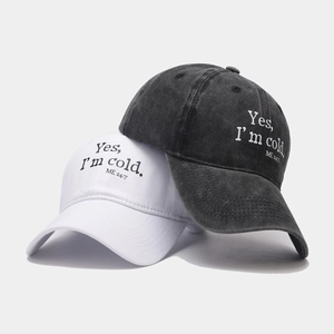 Vintage washed baseball caps in white and charcoal grey with embroidered side lettering