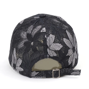 Back view of women's lace baseball cap with black and white floral embroidery