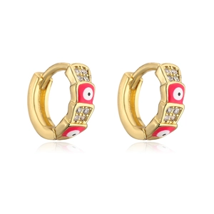 Detail of gold hoops with red enamel evil eyes and shimmering zircon stones