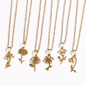 Detailed flat lay of six 18k gold plated stainless steel necklaces with birth flower charms
