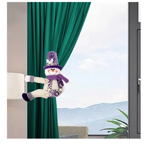 Detail of a purple sequined snowman curtain tieback holding a green drape in a home setting