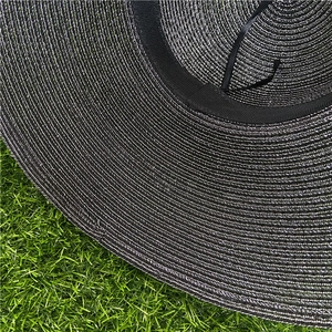 Detail of sun hat showing inner sweatband and adjustable drawstring on woven texture