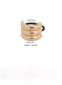 Detail view of a triple-layered gold alloy hair cuff with high-elastic black hair tie