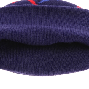 Macro detail of navy blue double-layered rib knit texture on children dinosaur beanie