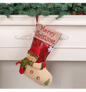 Detail of Christmas stocking with snowman decor and Merry Christmas embroidery on fireplace
