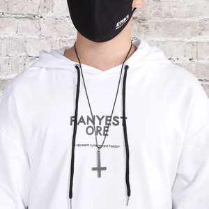 Titanium steel inverted cross pendant necklace worn by male model over white hoodie