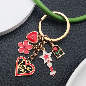 Golden heart keychain with red enamel love charms and rose in glass dome pendant