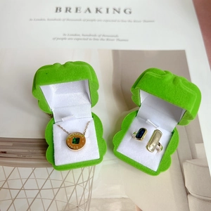 Creative frog shaped green velvet jewelry box featuring rose gold necklace and gem ring