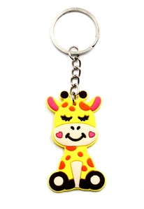 Macro detail of cute yellow PVC giraffe keychain with orange spots and metal ring