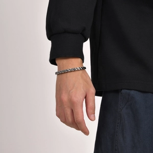 Vintage silver stainless steel twisted cuff bracelet for men on a model's wrist