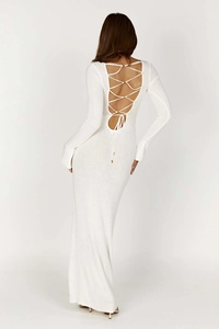 Detail of the white knitted maxi dress featuring a cross lace-up open back design