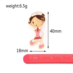 Detail view of cartoon nurse enamel pin with dimensions 40mm and weight 6.5g shown on ruler