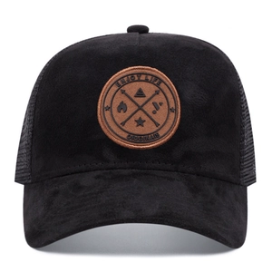 Detail of black mesh trucker hat with Enjoy Life leather patch and breathable mesh