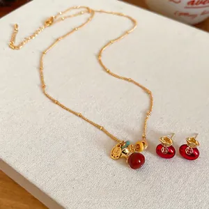 Gold-plated lucky pouch jewelry set with red beads necklace and matching earrings