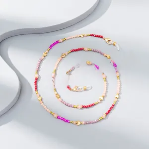 Macro view of colorful crystal beads and gold heart accents on a stylish eyewear chain