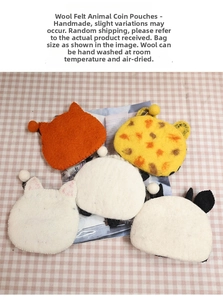 Detail of wool felt animal coin purses showing handmade texture and zipper balls