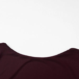 Detailed close-up of the elegant round neckline and fine stitching of the maroon dress