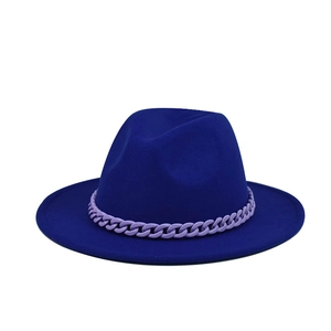 Detail of royal blue felt fedora hat featuring a decorative light purple plastic chain link