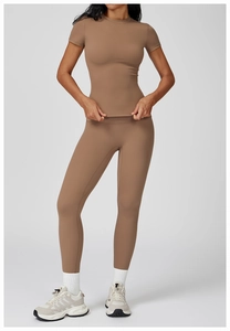 Detail of high-waist yoga leggings and slim fit t-shirt in mocha professional sport fabric