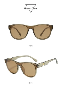 Detail view of oval sunglasses with transparent green frames and brown lenses
