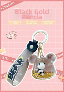 Détail du porte-clés panda liquide avec paillettes dorées et dragonne en silicone