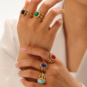 Detail of vintage gold-plated rings featuring natural lapis lazuli and colorful stones