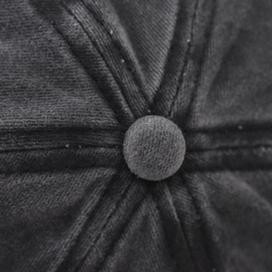 Macro shot of cotton baseball cap crown with central button and stitched seam texture