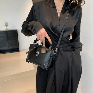 Gothic black leather crossbody bag with silver skull relief and rivet detailing