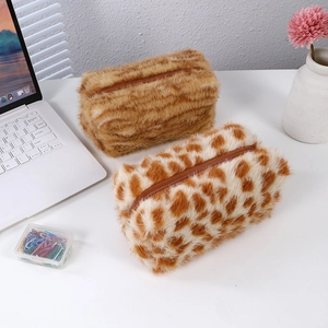 Large plush pencil cases with leopard and tiger prints, soft storage pouches on desk