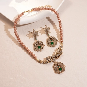 Vintage jewelry set with pearl necklace and green gemstone pendant in luxury style