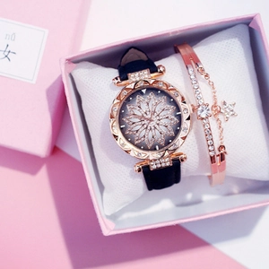 Close-up of rose gold cat-themed watch and star bracelet set in a pink gift box
