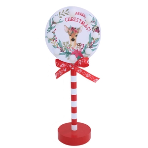 Close-up of wooden Christmas STOP sign LED light with red heart bow and deer motif