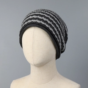 Close-up of grey striped knitted beanie texture and thick weave pattern on mannequin