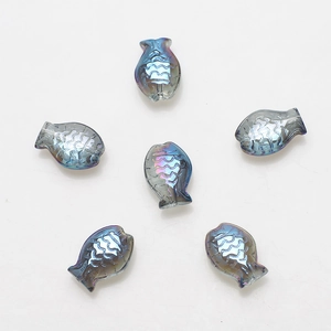 Macro shot of six fish-shaped glass pendants with iridescent blue rainbow finish