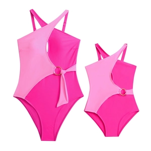 Detail of hot pink colorblock one-piece swimsuits with gold ring and halter design
