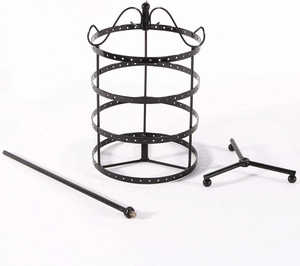 Components of black rotating earring organizer featuring a metal pole and tripod base