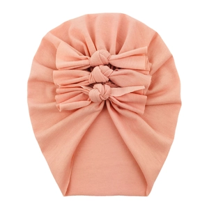 Detailed view of pink cotton baby turban featuring a decorative triple bow design