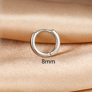 Detail view of 8mm silver hoop earring on silk background with snap closure