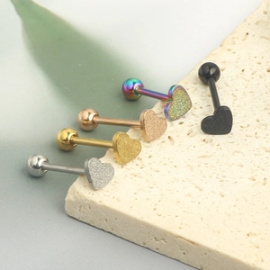 Macro shot of heart-shaped frosted tongue rings in five colors on a stone base