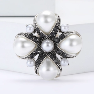 Vintage baroque alloy brooch with large white pearls and black crystals on silver frame